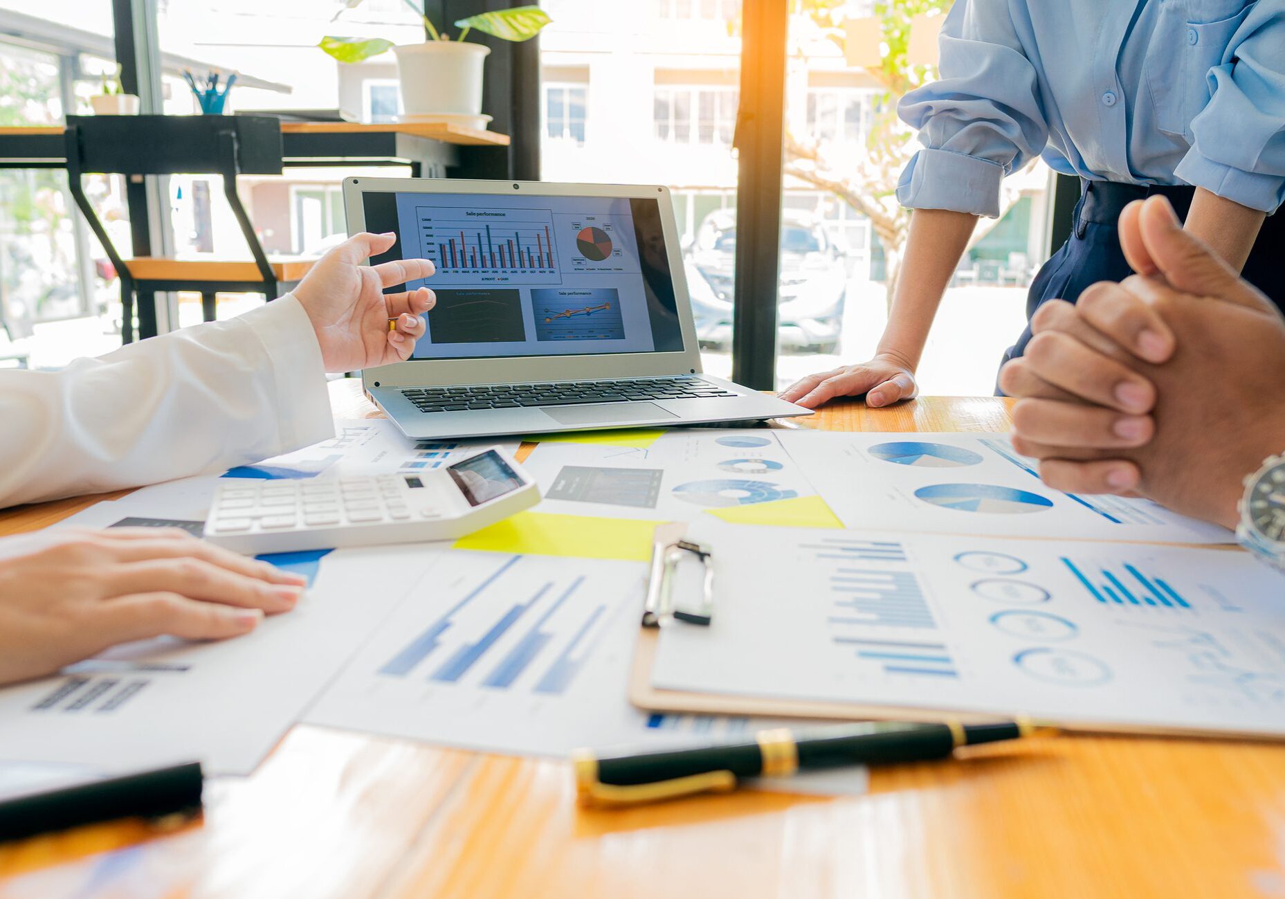 Meeting with business people to discuss and brainstorm ideas on financial reports.