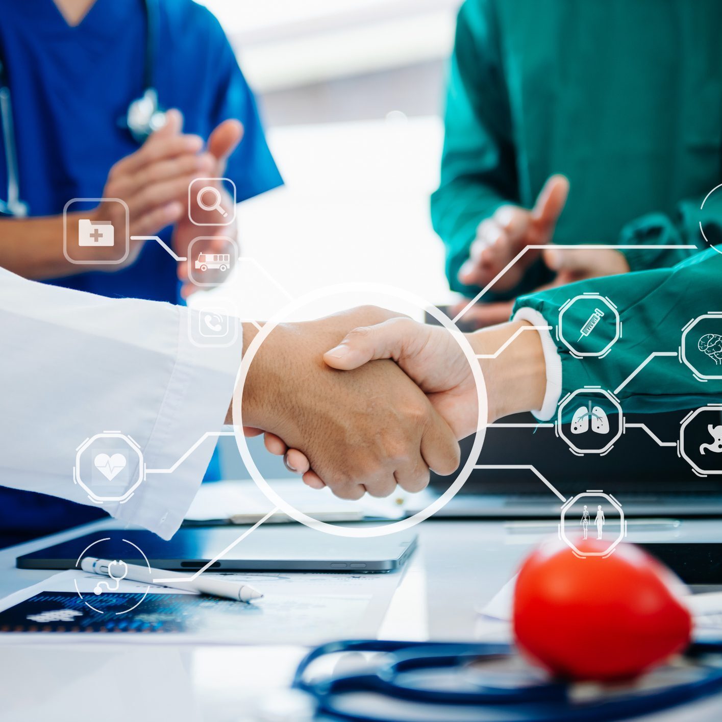 Doctors shaking hands with medical icons overlay.