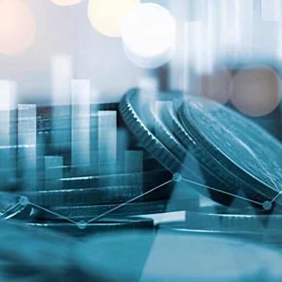 Coins with financial graphs in background.