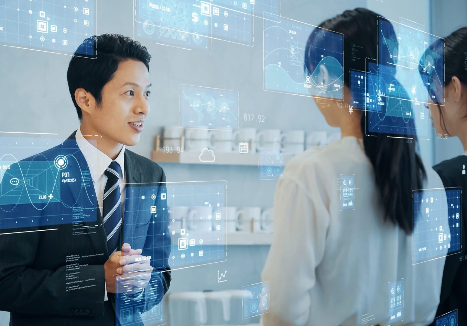 People interacting with digital interface holograms.