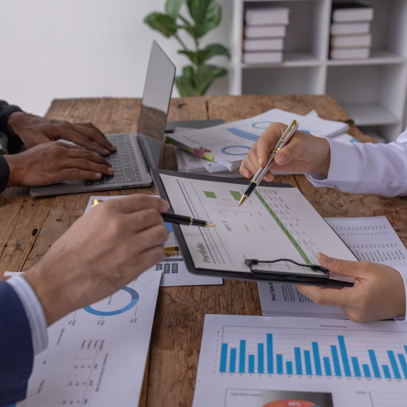 Business team analyzing financial charts together.