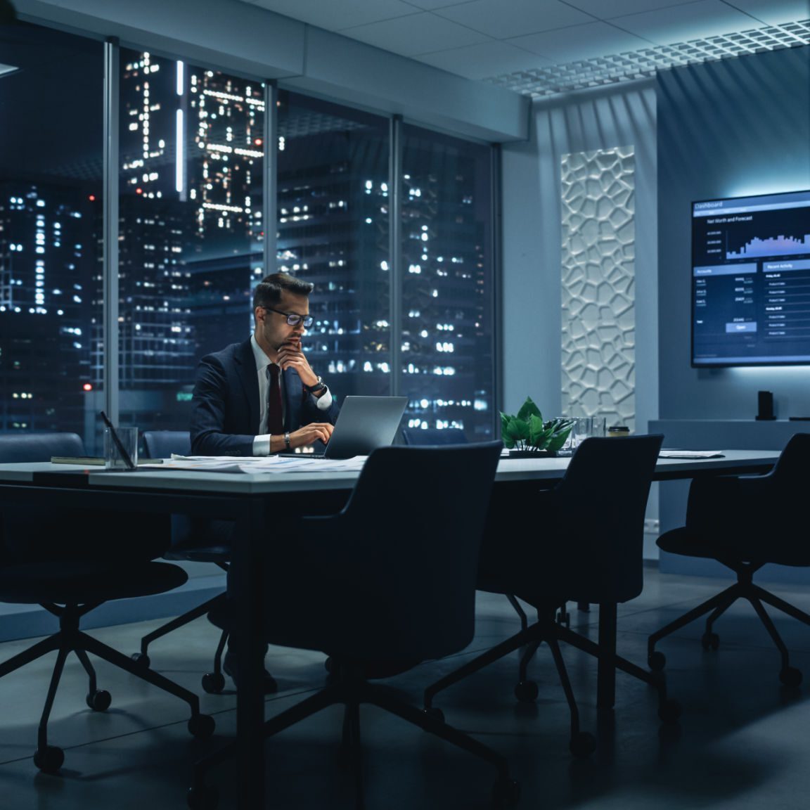 Businessman working late in modern office.