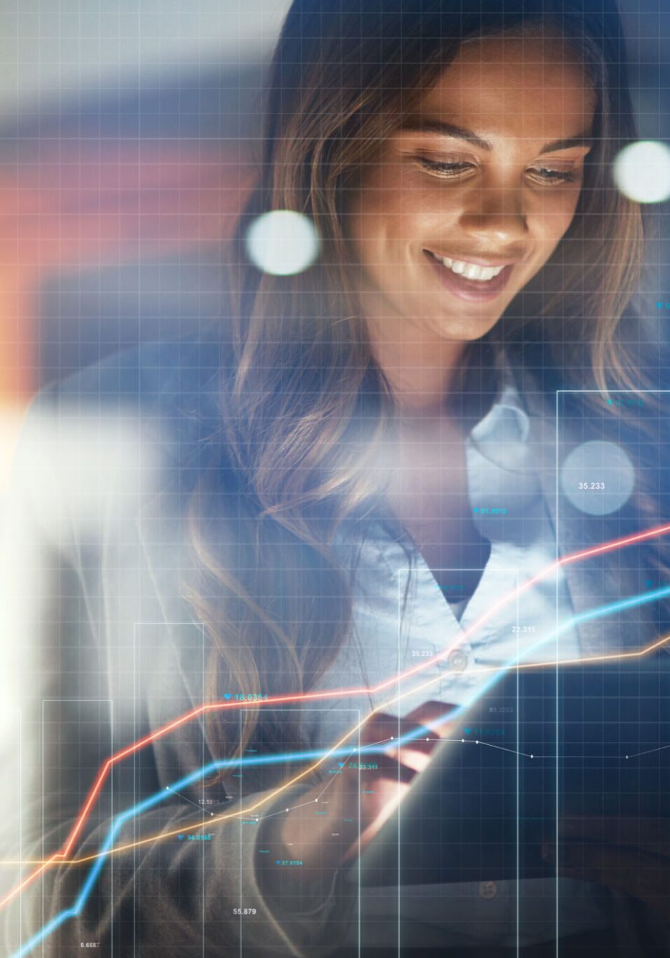 Smiling woman analyzing digital financial graphs.